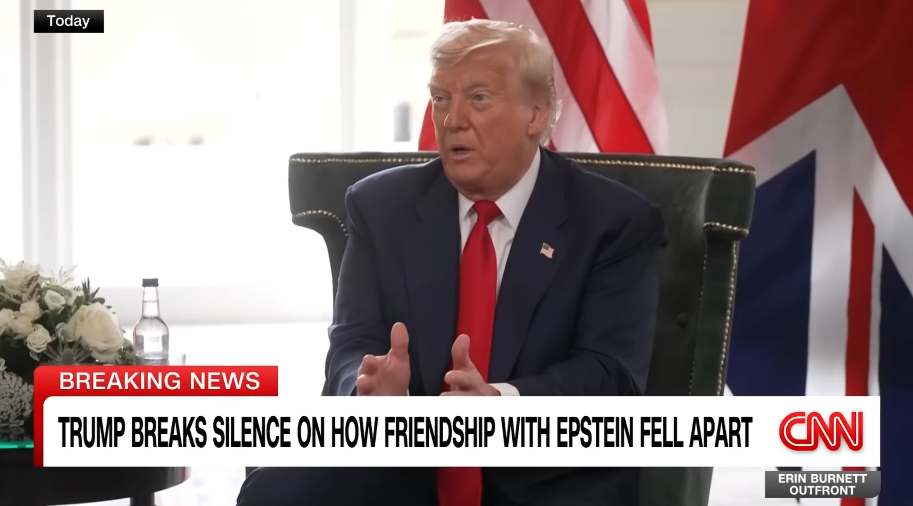 Man in suit speaks during a CNN interview. The screen shows a news headline about Trump discussing his friendship with Epstein