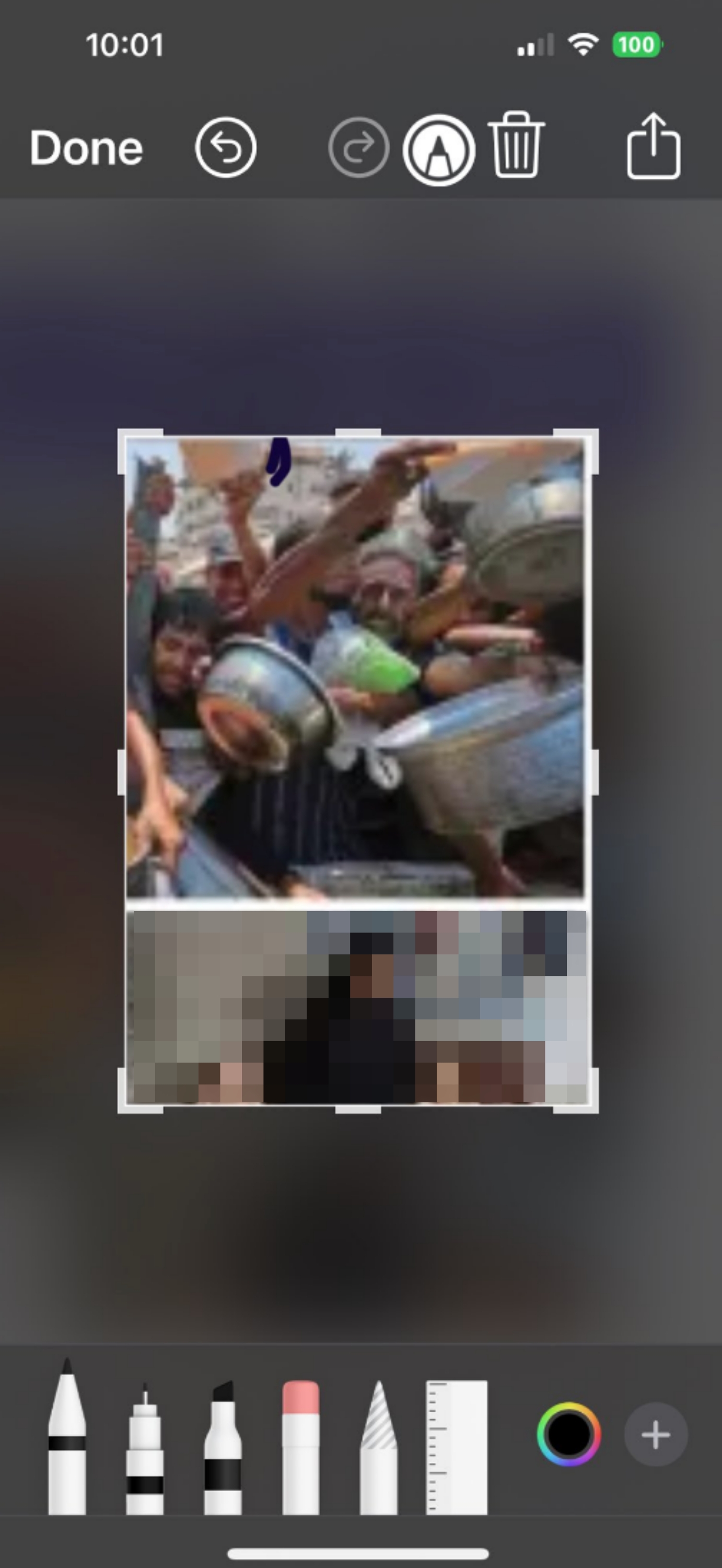 A screengrab of a cropped photo showing the starvation crisis in Palestine that is open in an iPhone's photo editor. There is a dark blue scribble close to the top of the crop outline.