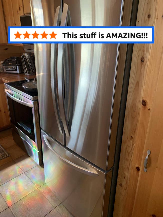 Stainless alloy fridge with French doors and bottommost freezer successful a modern room setting, adjacent to an oven and woody cabinets