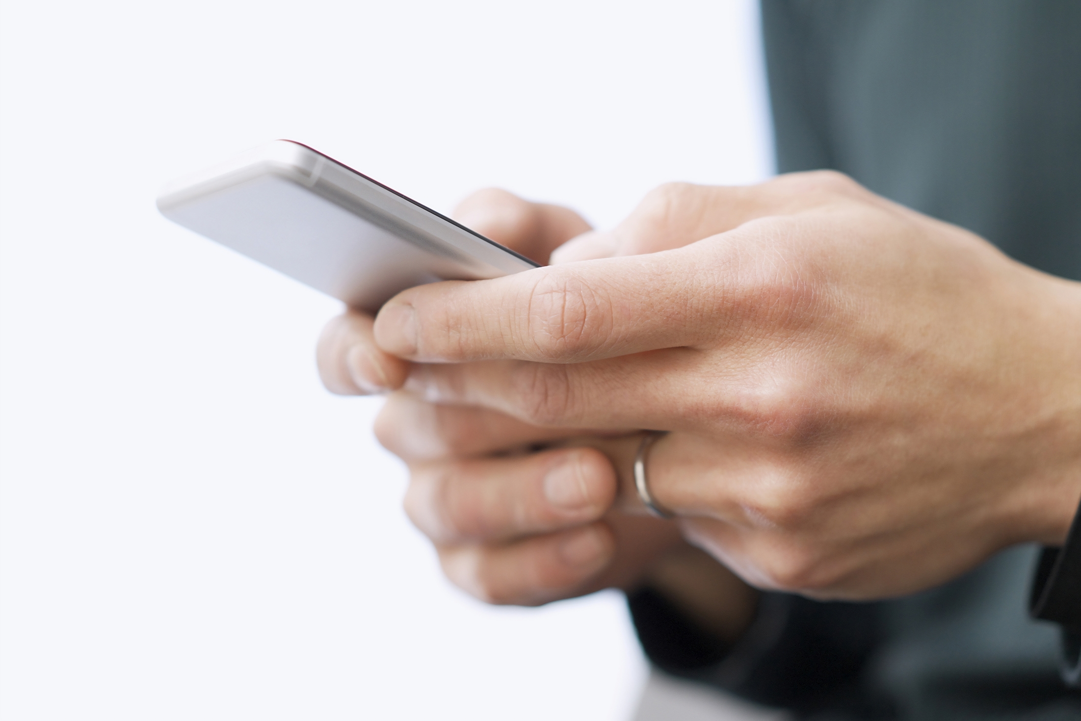 Person holding a smartphone, focusing on their hands and the device