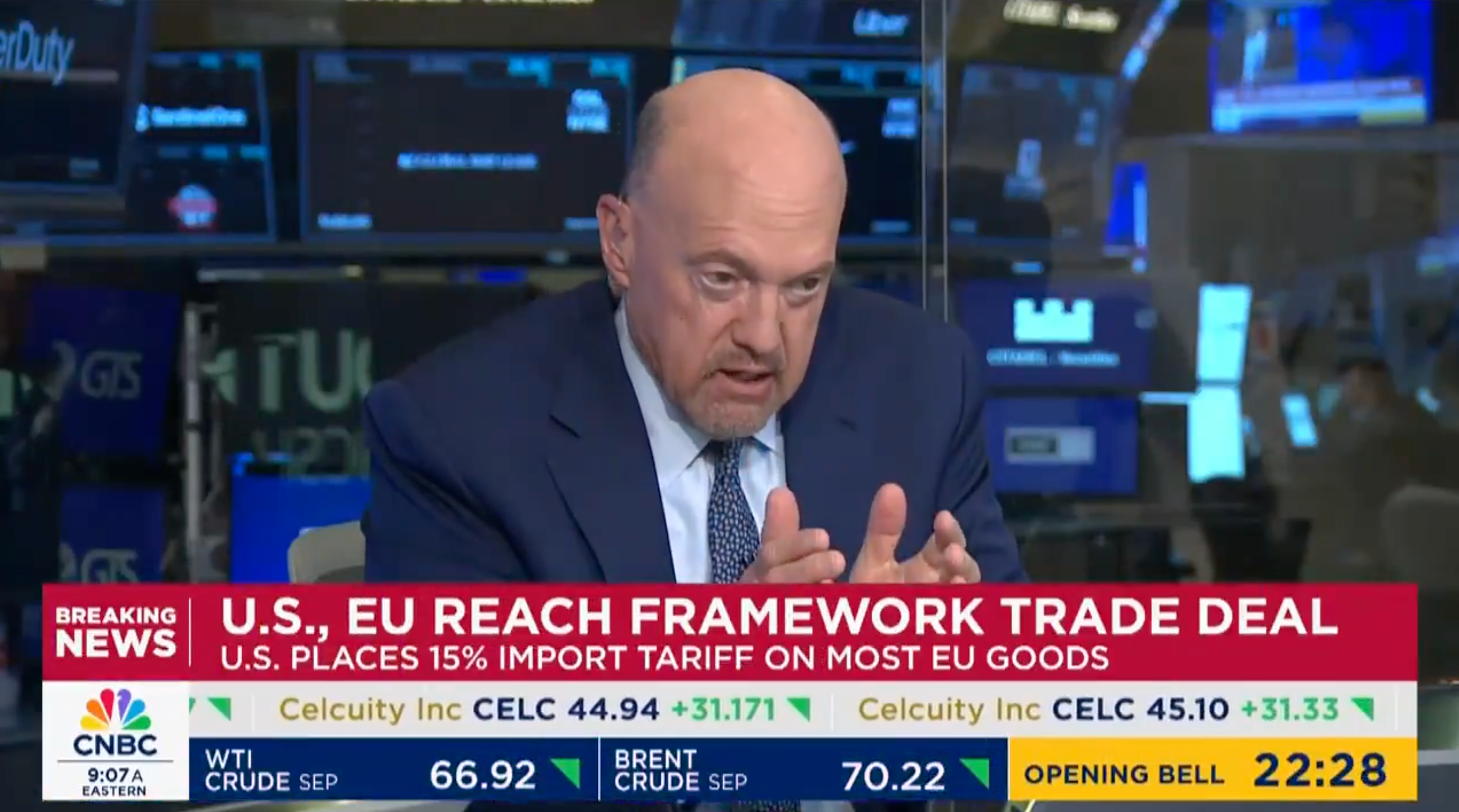 A man in a studio gestures while discussing a U.S.-EU trade deal. The news ticker mentions a 15% U.S. tariff on EU goods