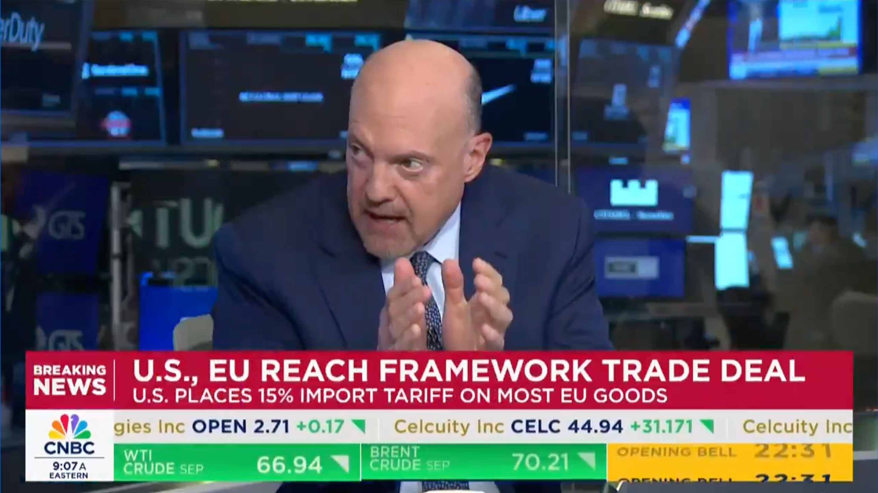 Man in suit discusses U.S.-EU trade deal on news channel, with ticker showing stock market updates