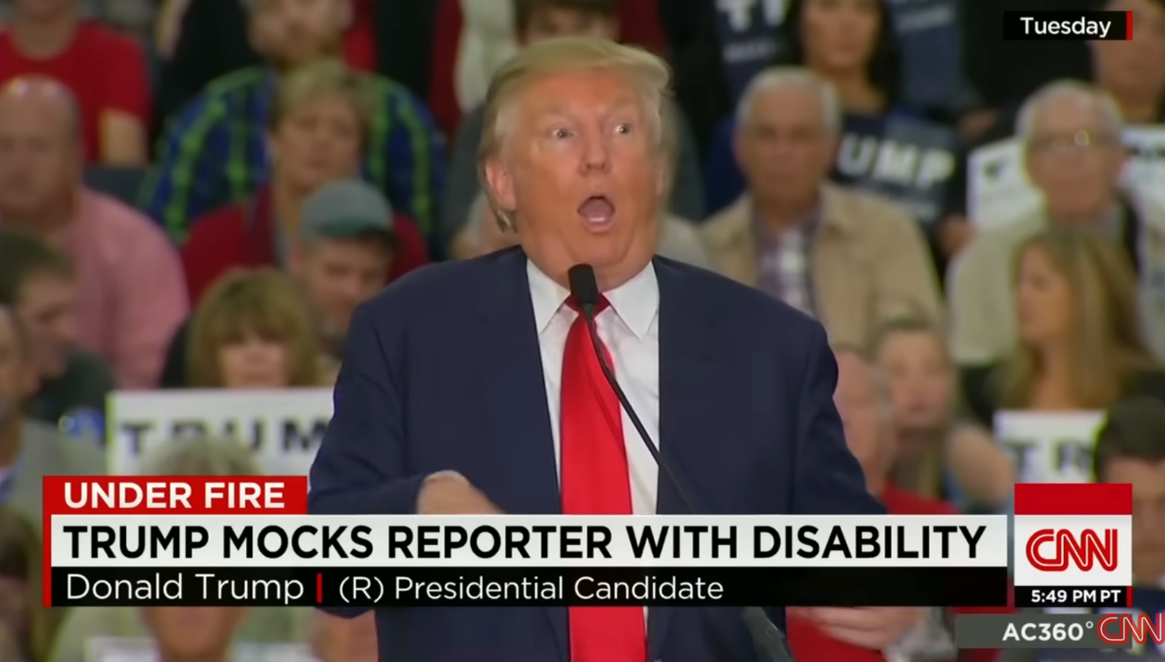 Donald Trump speaking animatedly at a rally, with a news headline stating he mocked a reporter with a disability