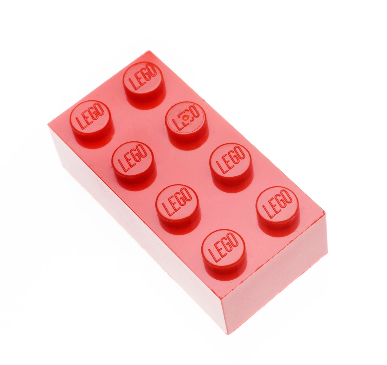 Red LEGO brick with eight studs embossed with "LEGO," isolated on a white background