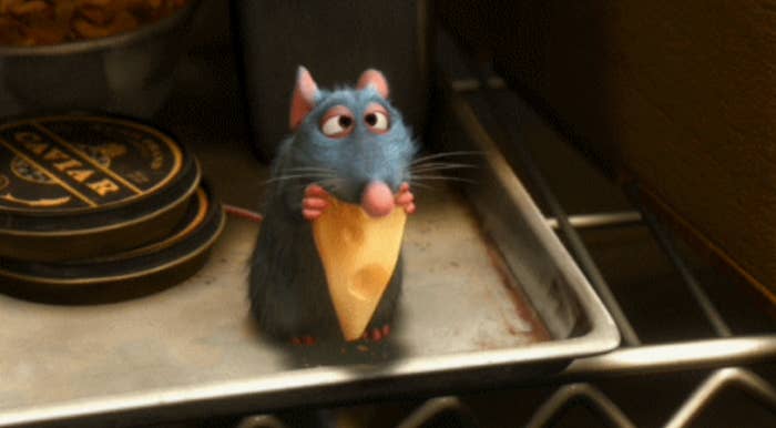Remy holding a wedge of cheese in Ratatouille