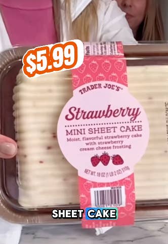 A person holds a packaged Trader Joe's Strawberry Mini Sheet Cake with cream cheese frosting. Price tag reads "$5.99"