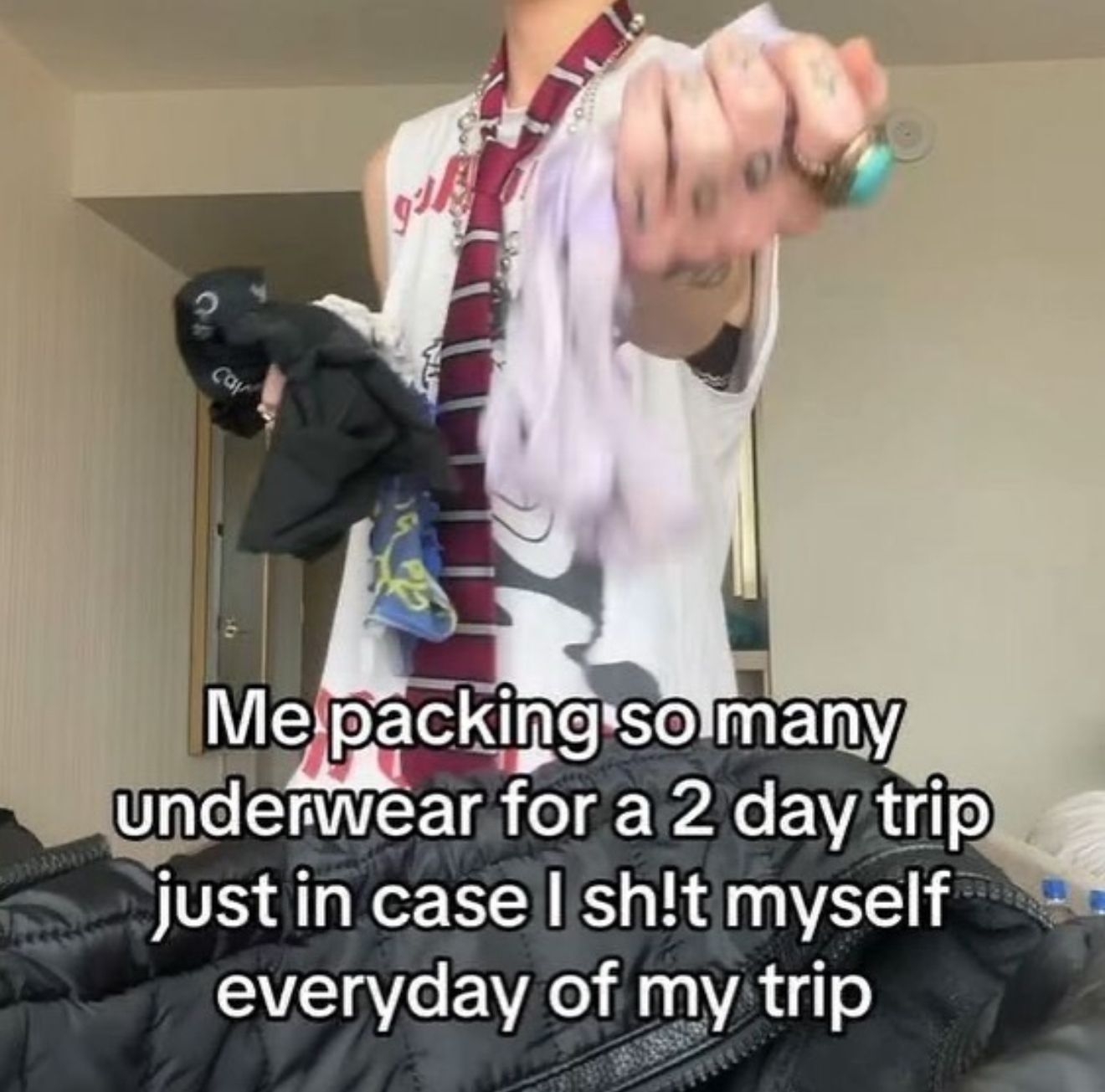 Person humorously packing excessive underwear for a short trip, with text joking about potential travel mishaps