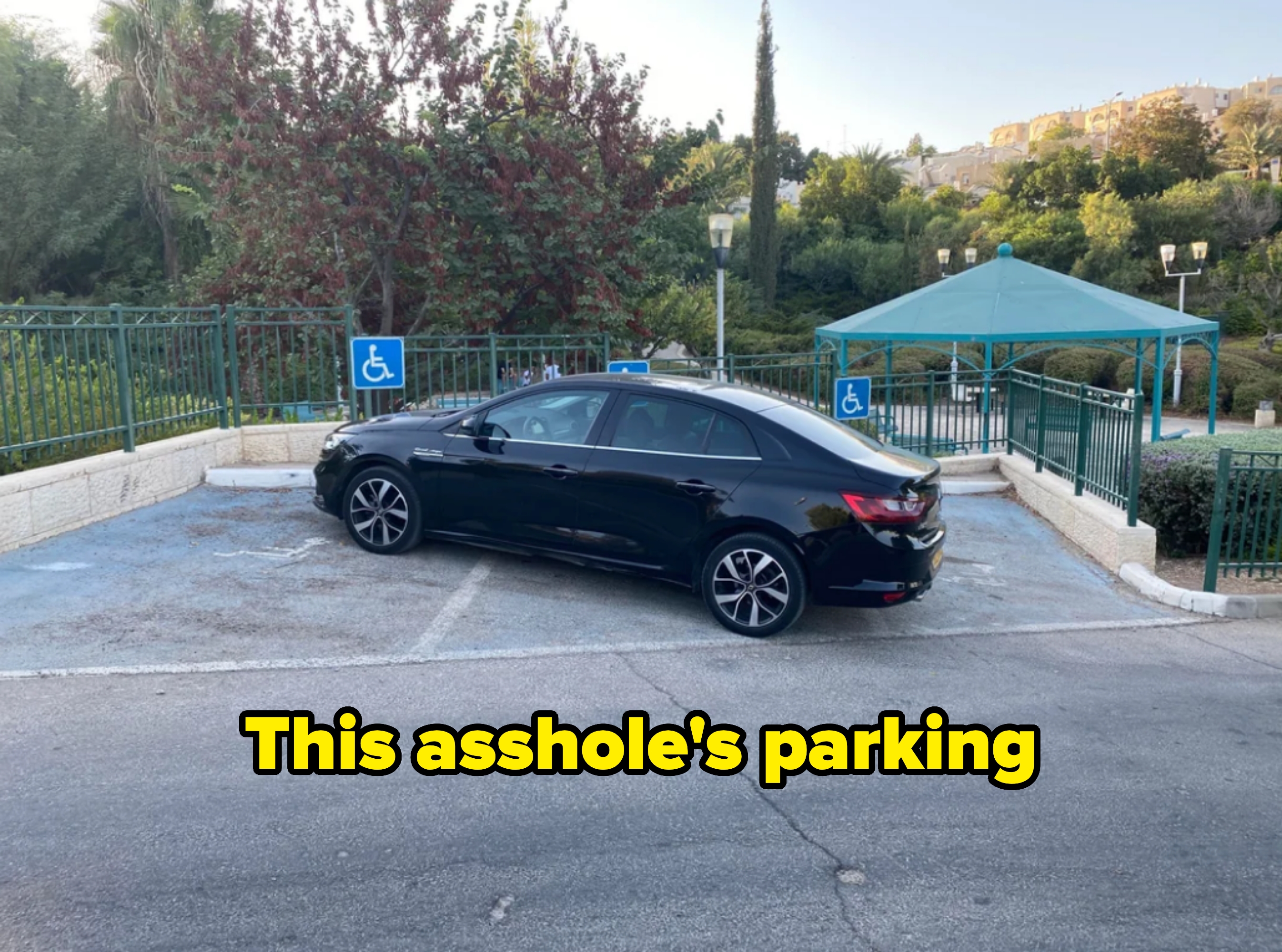 Car improperly parked across two accessible parking spaces