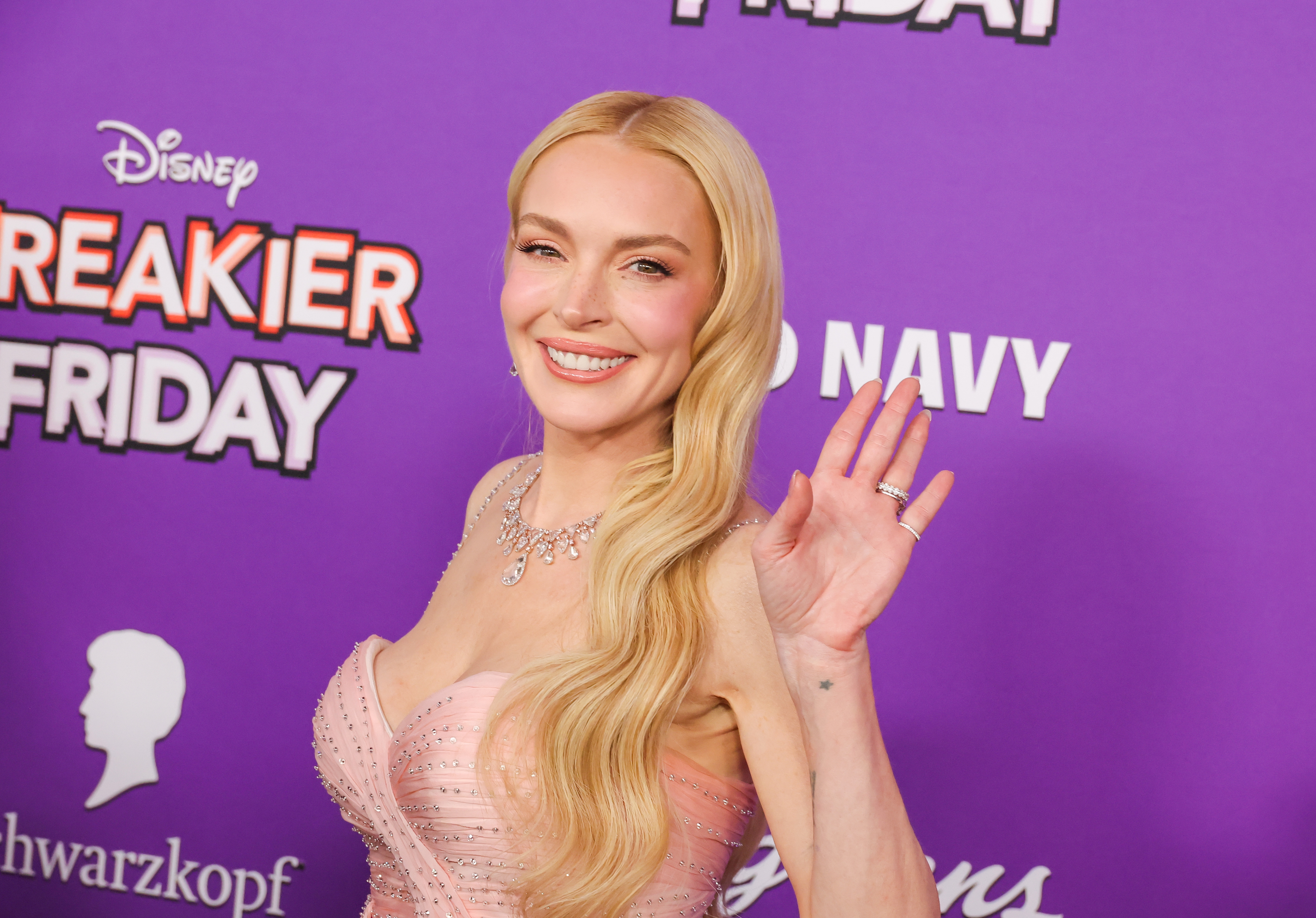 Lindsay Lohan in elegant, strapless dress with long hair waves