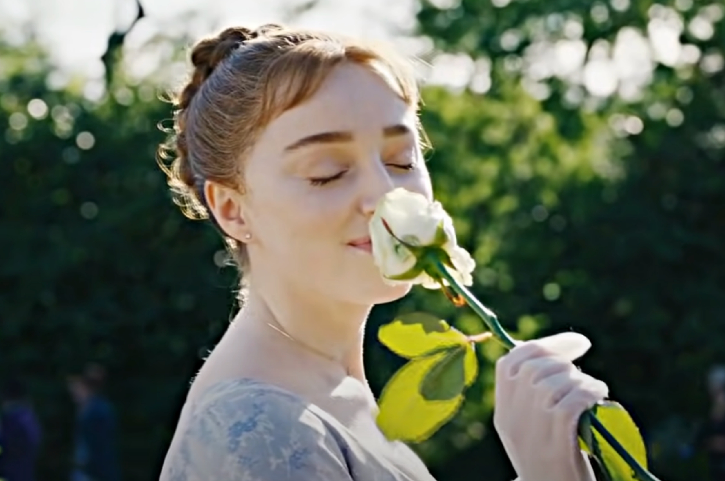 Daphne from Bridgerton sniffing a rose