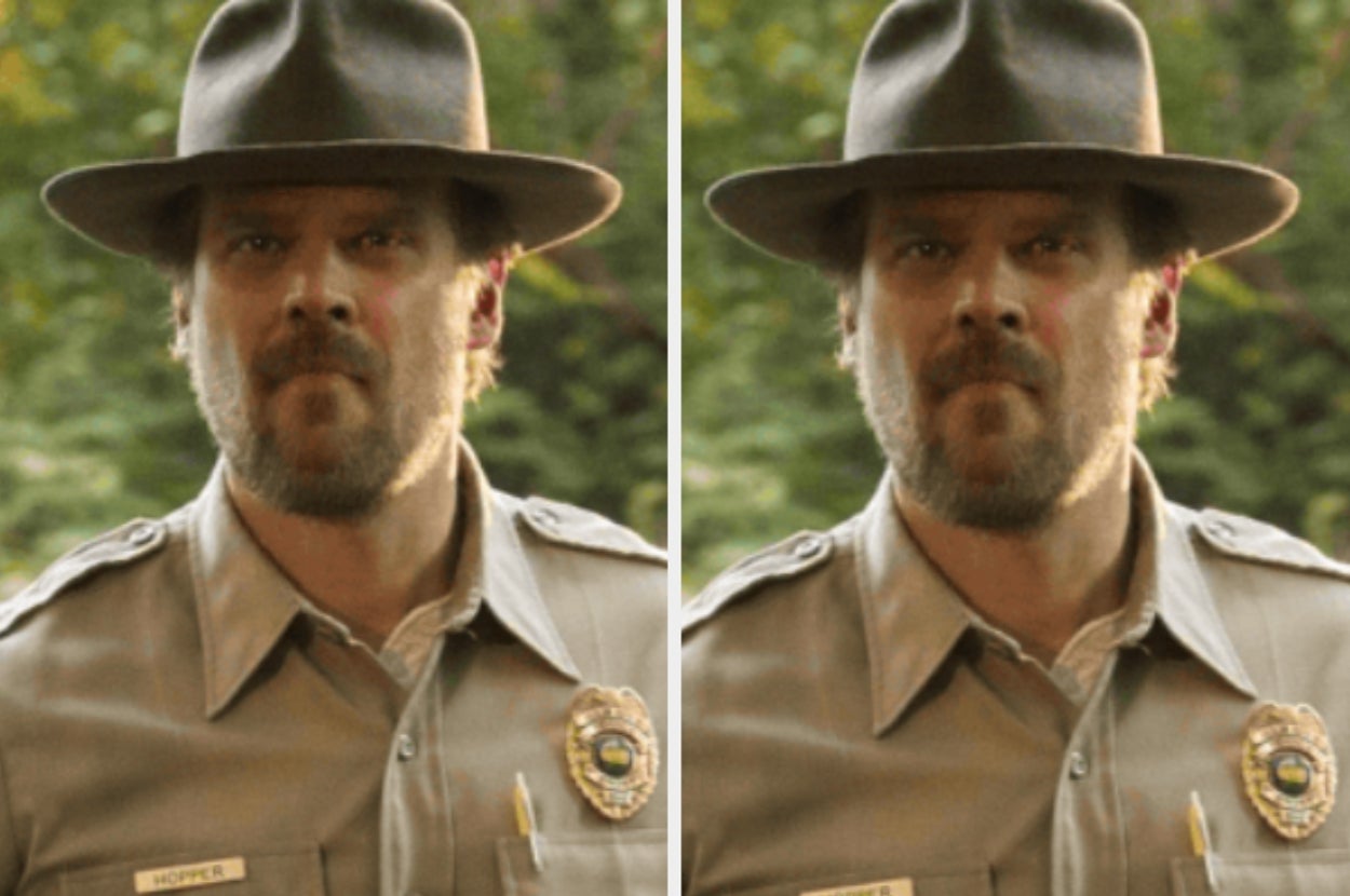 A man in a ranger uniform with a badge and hat stands outdoors, appearing serious