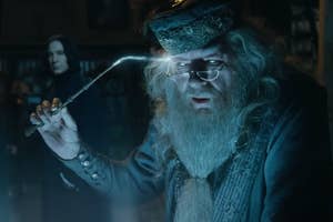 Dumbledore using a glowing wand to remove a memory, Snape standing behind him