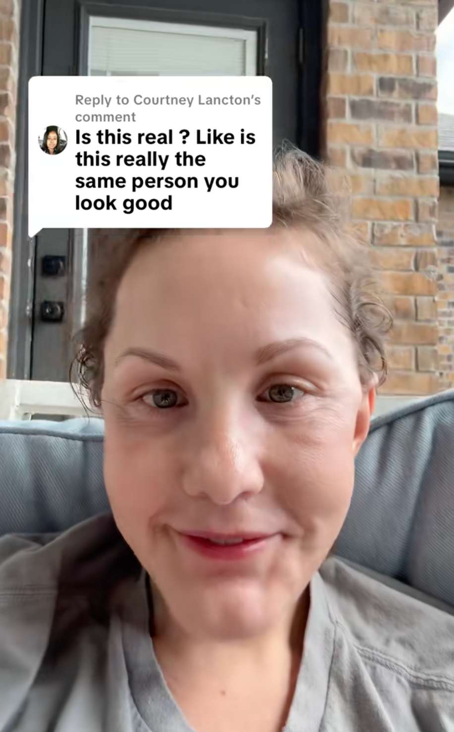 Person responding to a comment asking if photos are of the same person, with a relaxed pose on a sofa, referencing appearance improvement