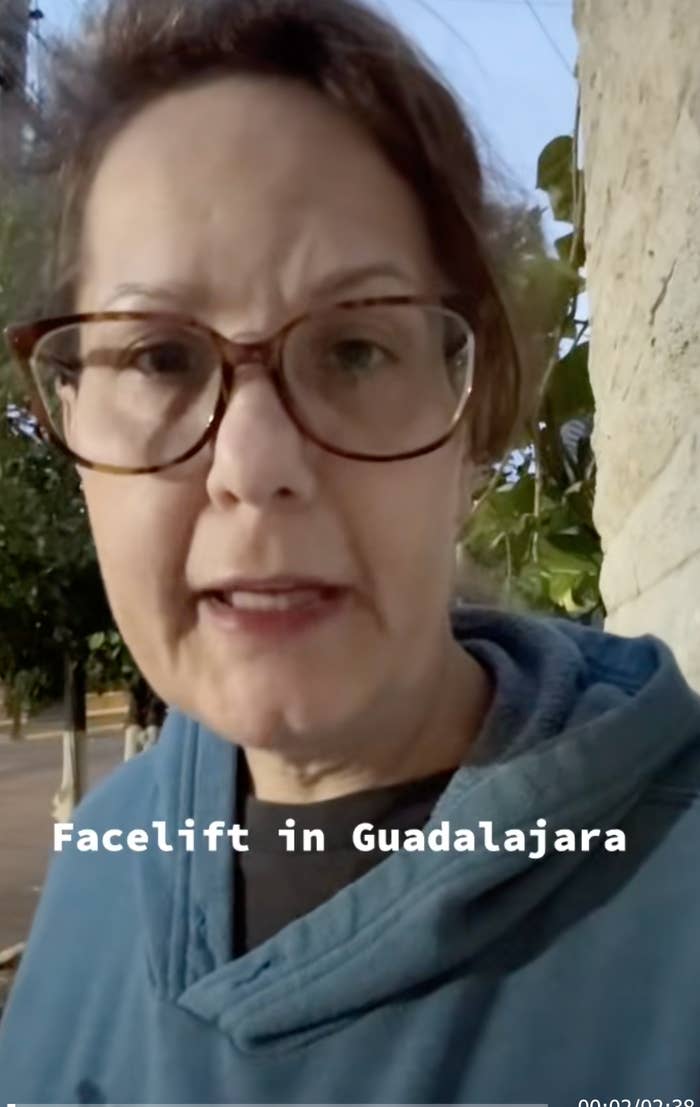 A person wearing glasses and a hoodie talks about getting a facelift in Guadalajara