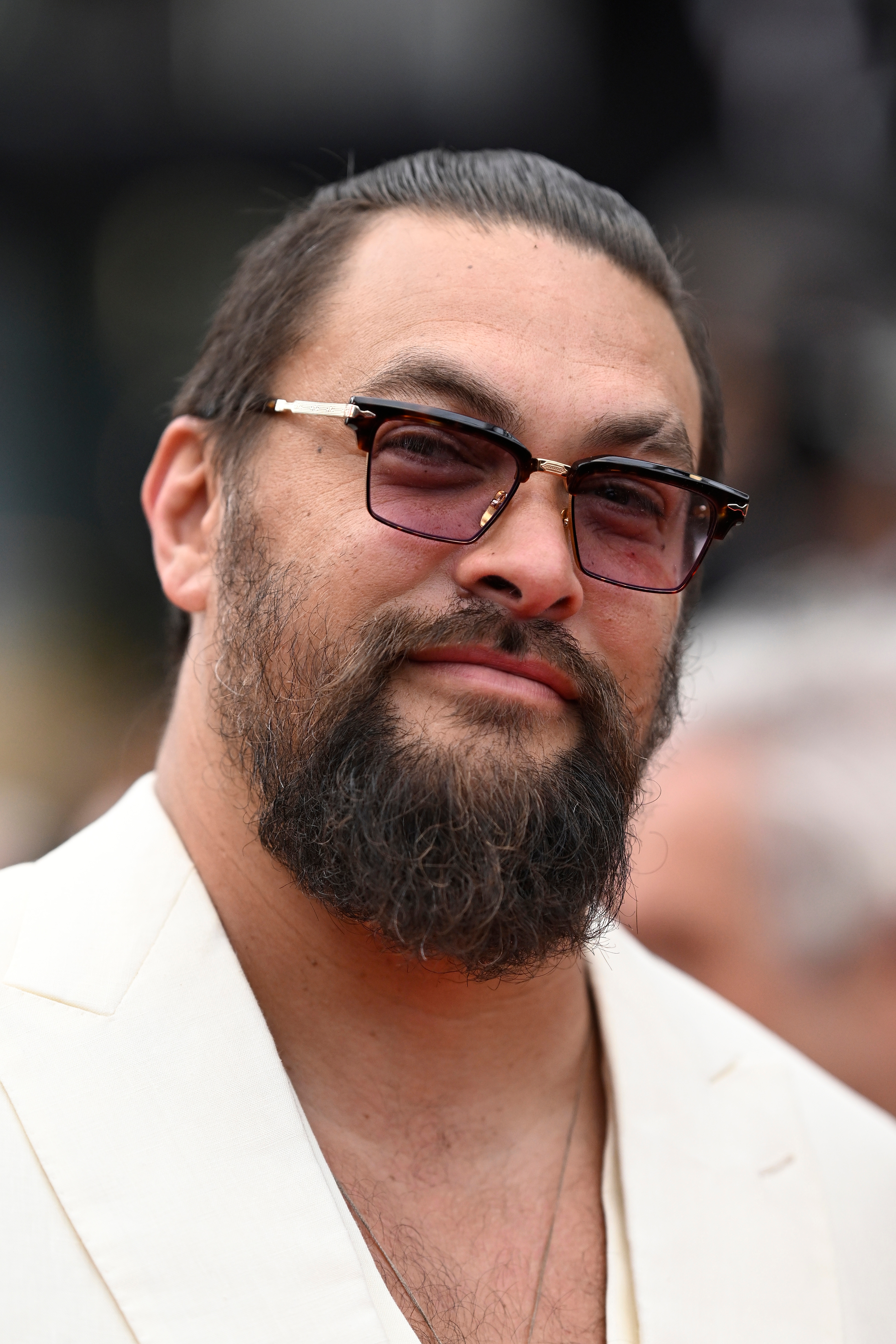 Jason Momoa with a full beard on a red carpet