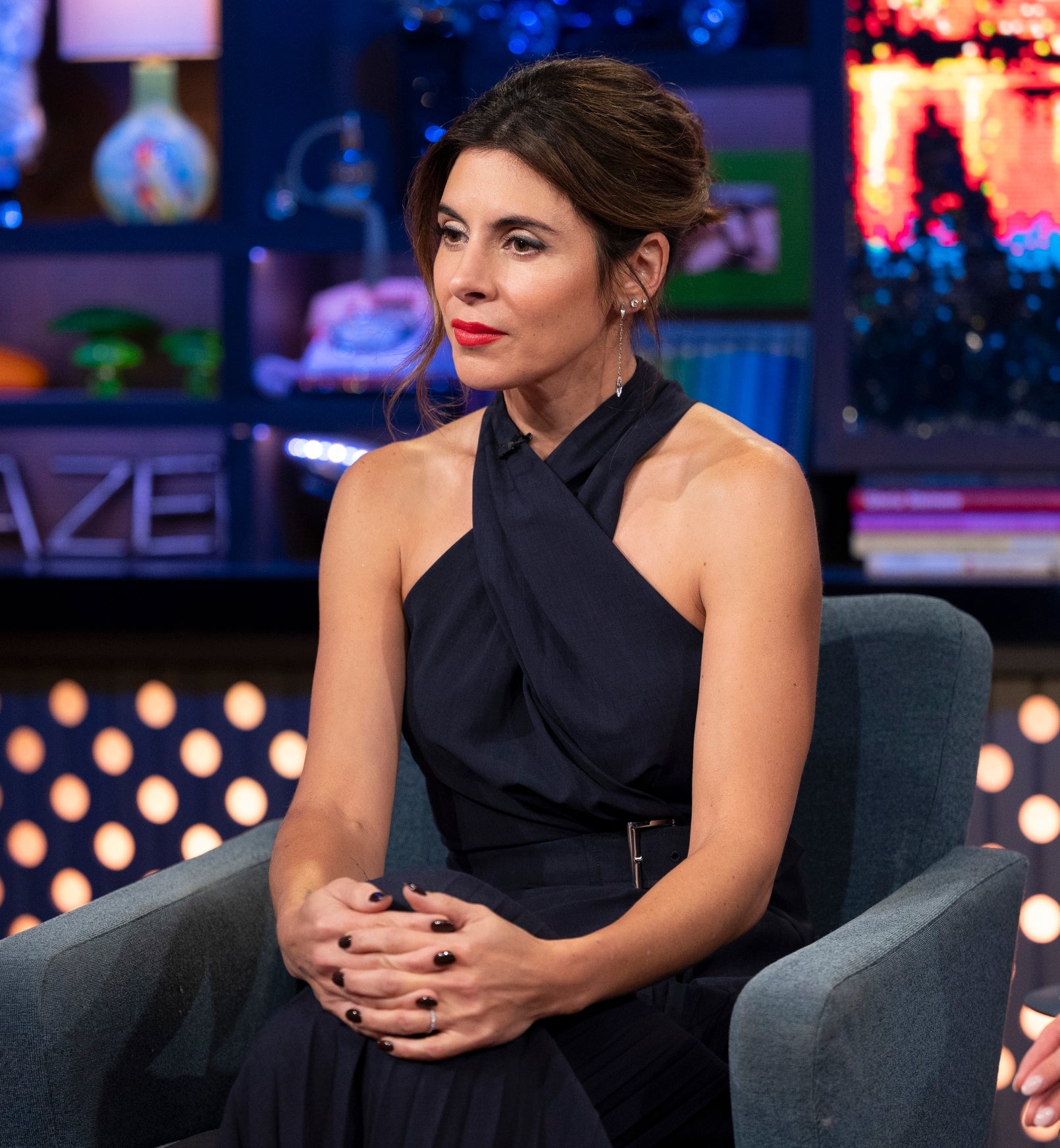 Jamie-Lynn Sigler sitting in a talk show studio