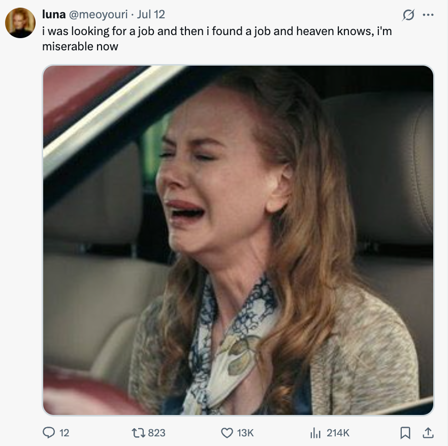 A woman inside a car is crying dramatically