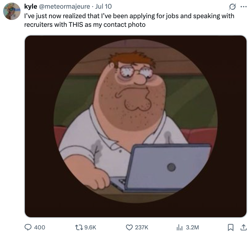 Peter Griffin sitting at a laptop, looking exhausted