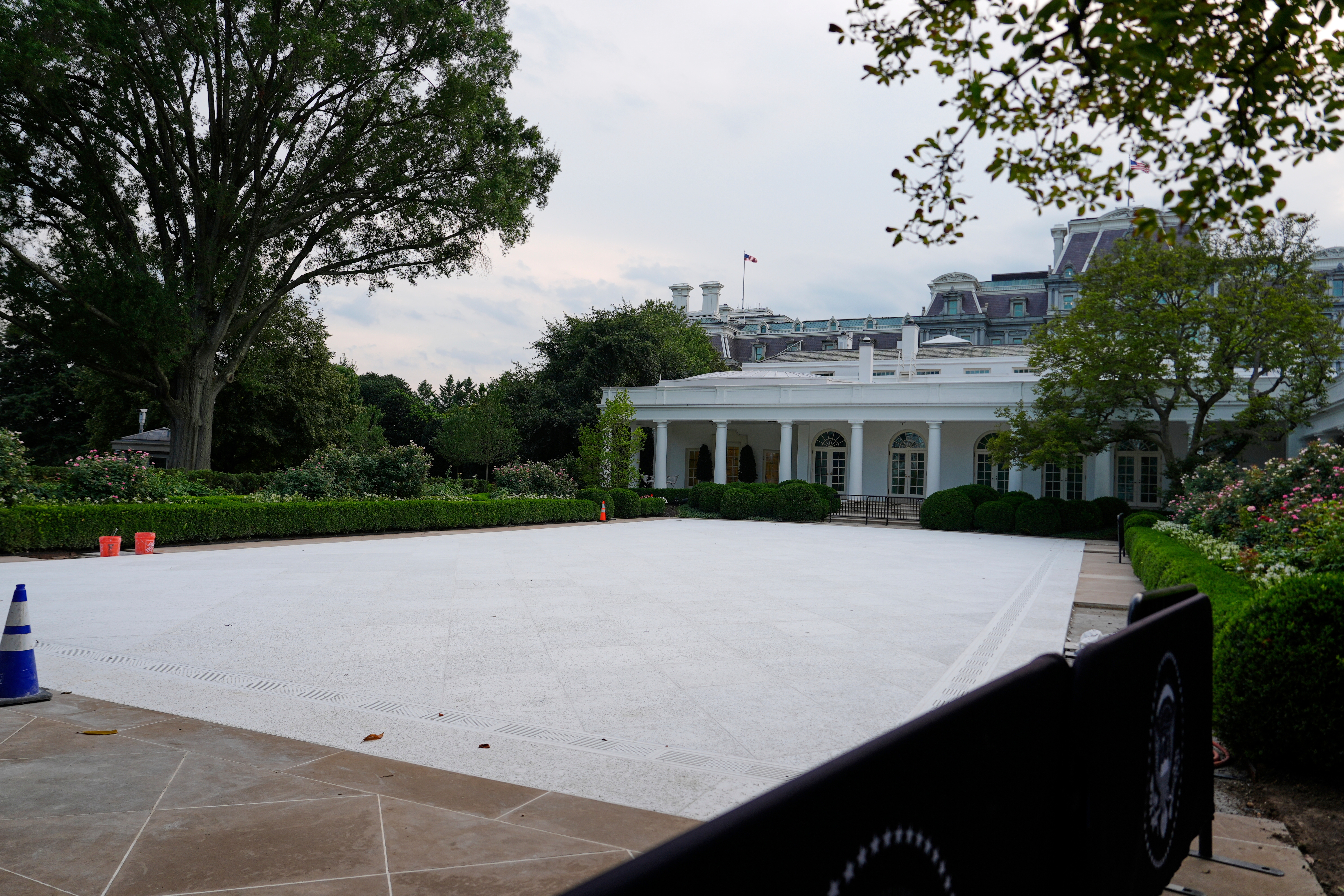 Wide view of the White House&#x27;s South Portico with a newly paved, empty area and surrounding greenery