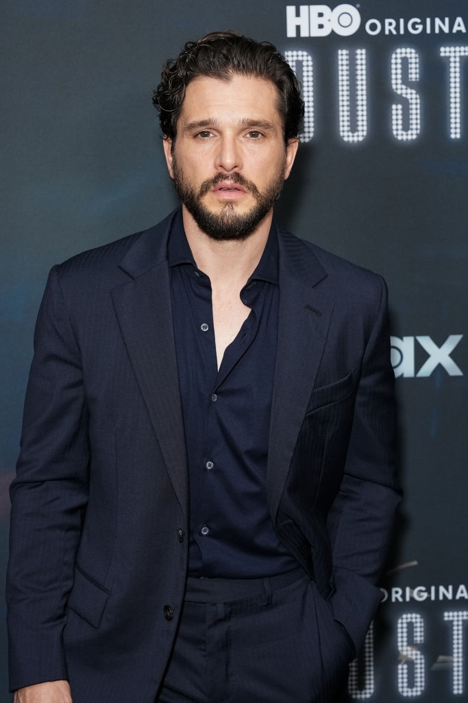 Man in a dark suit on a red carpet at an event for an HBO show