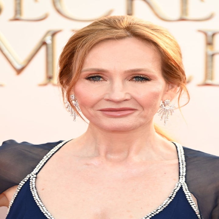 A person on the red carpet wearing a gown with intricate beadwork and sparkling earrings, looking towards the camera