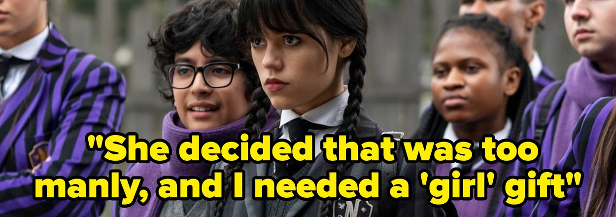 A group of students in school uniforms; central figure is serious with braided hair. Text: "She decided that was too manly, and I needed a 'girl' gift."