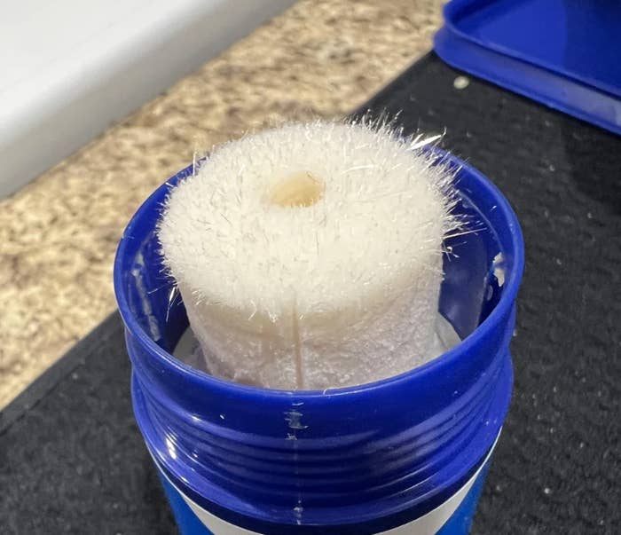 Vicks VapoStick with the cap removed, showing the solid stick of mentholated topical ointment inside the container