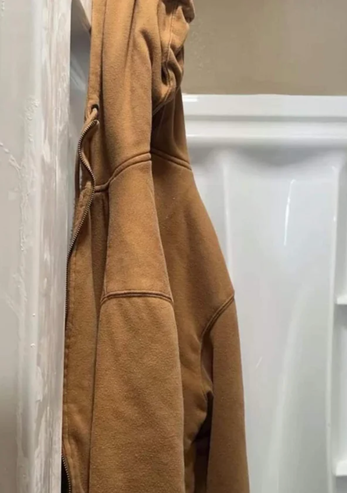 Hoodie hanging connected  a ablution  wall, appearing to beryllium  mistaken for a idiosyncratic   standing