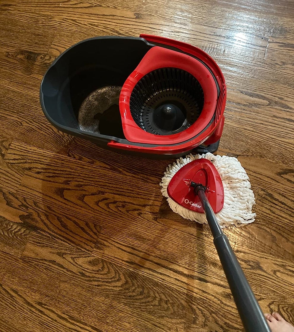 Spin mop set on hardwood floor, featuring a bucket with a wringer and a mop head