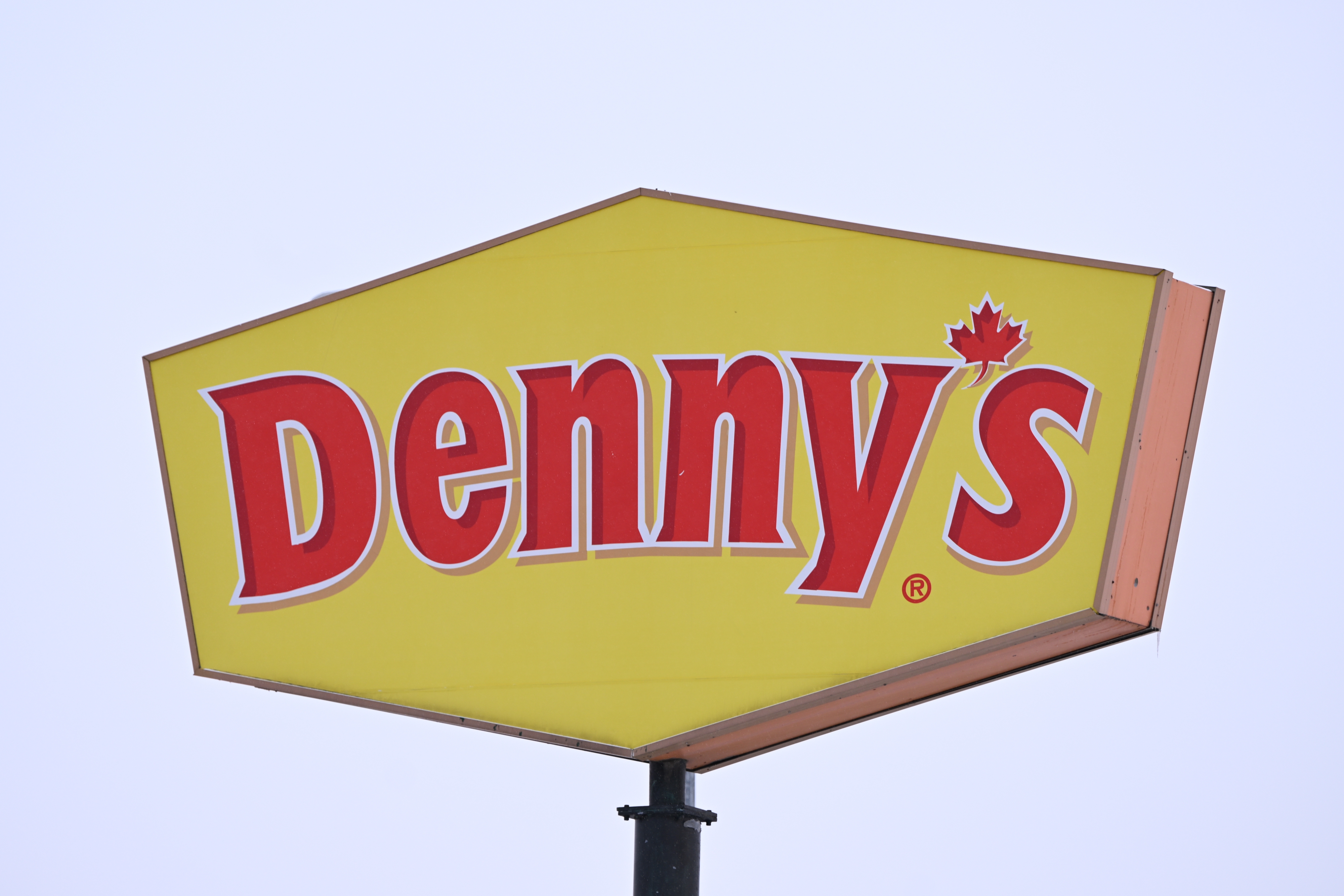 Denny's restaurant sign with a maple leaf, indicating a Canadian location