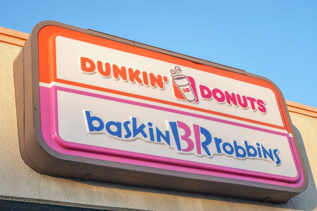 A sign displaying the logos of Dunkin' Donuts and Baskin-Robbins on the exterior of a building