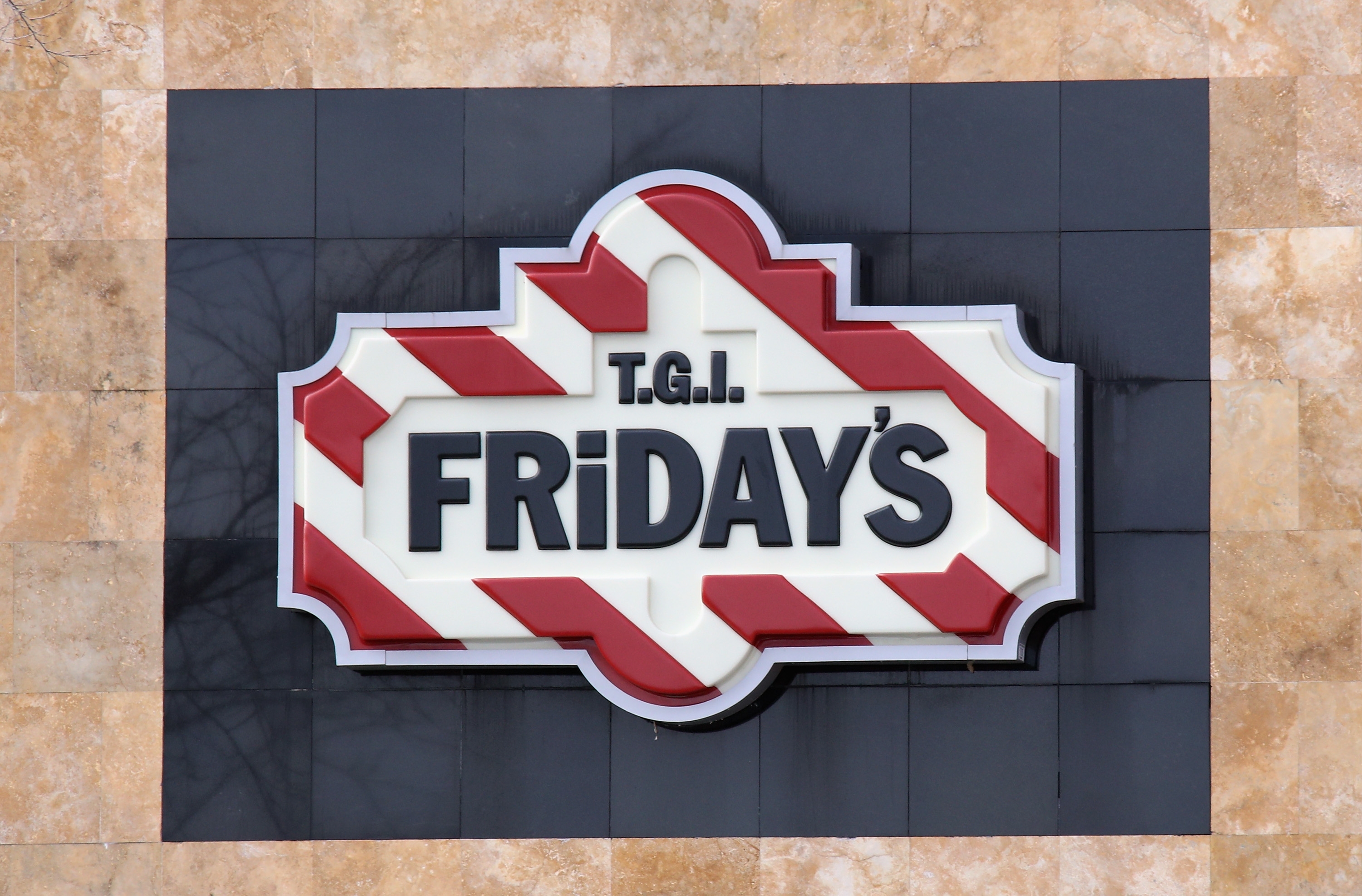 TGI Friday's restaurant sign with a geometric pattern displayed on a building exterior