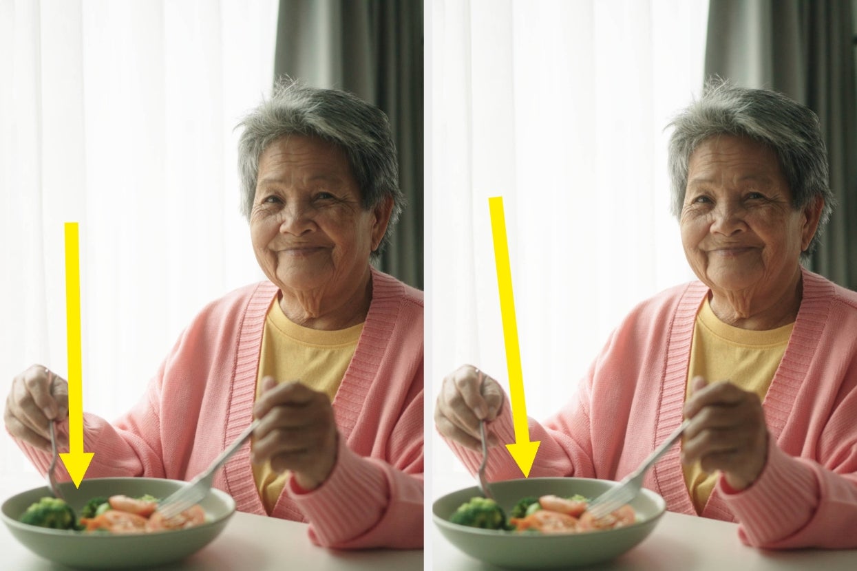 Older adult sitting at a table, pointing to a salad with broccoli and carrots, wearing a cozy cardigan, smiling warmly