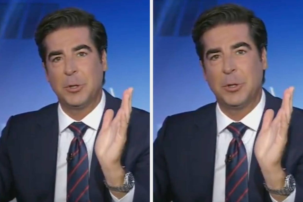 A person in a suit gestures expressively while speaking in a news studio