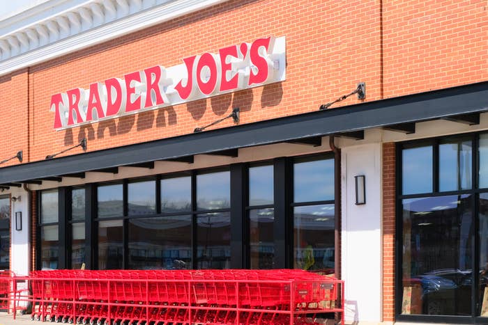 Exterior of a Trader Joe's store with reddish buying carts lined up successful front