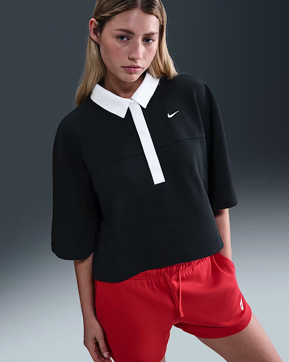 Model wearing the red and navy polo