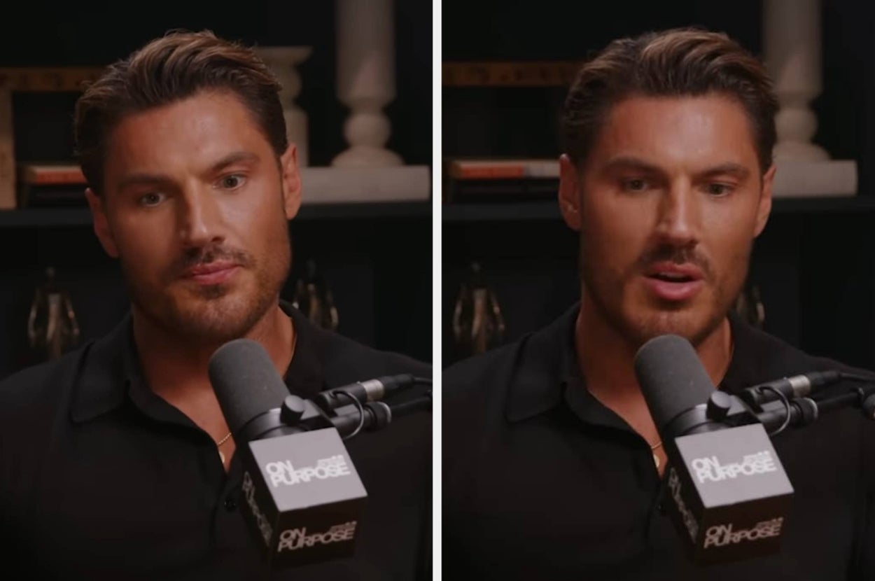 A person speaking into a microphone during a podcast, wearing a casual shirt, in a professional studio setting