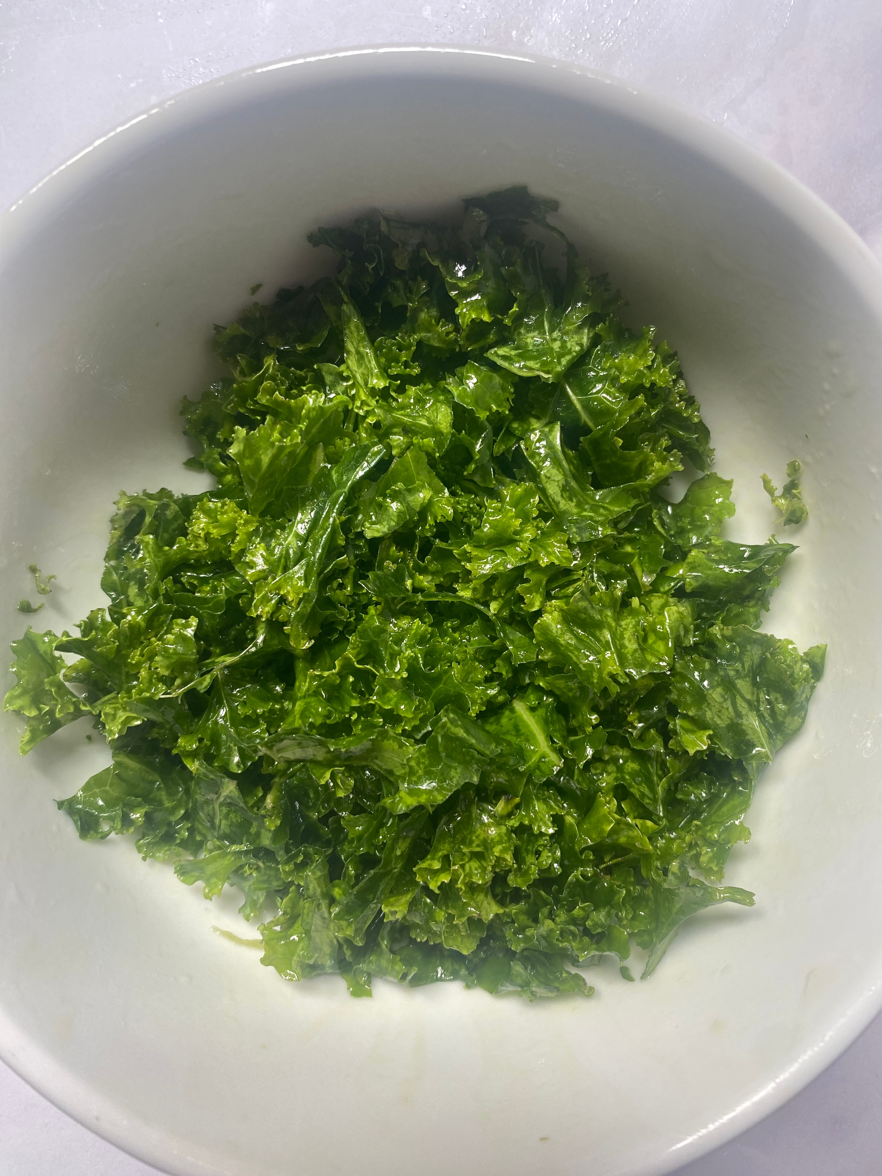 A bowl of curly kale leaves, freshly chopped and ready to be used in a dish