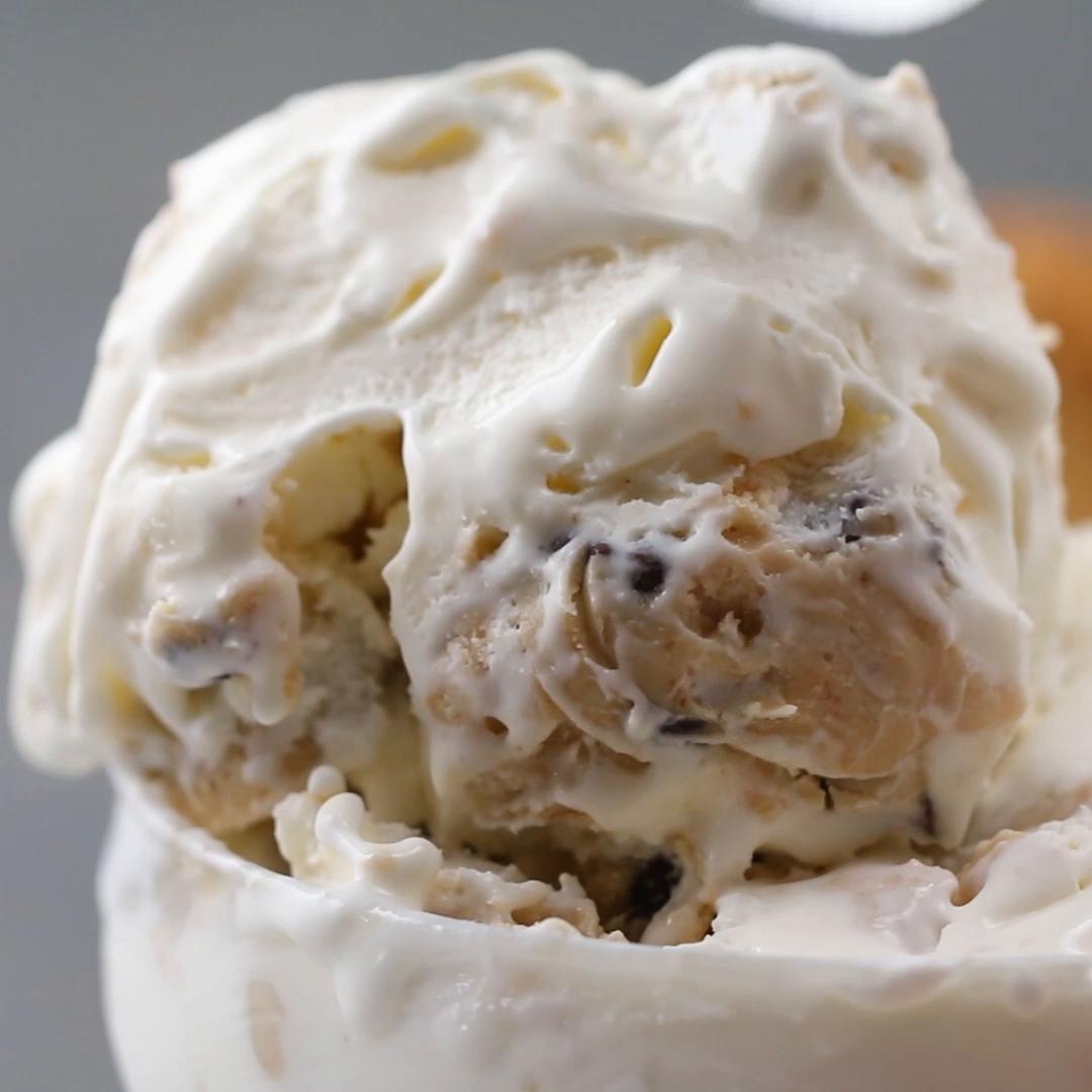 Close-up of creamy ice cream with cookie dough chunks, highlighting texture and richness. Ideal for a Tasty article about indulgent desserts