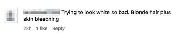 A comment criticizing someone for having blonde hair and using skin bleaching, implying they are trying to look white