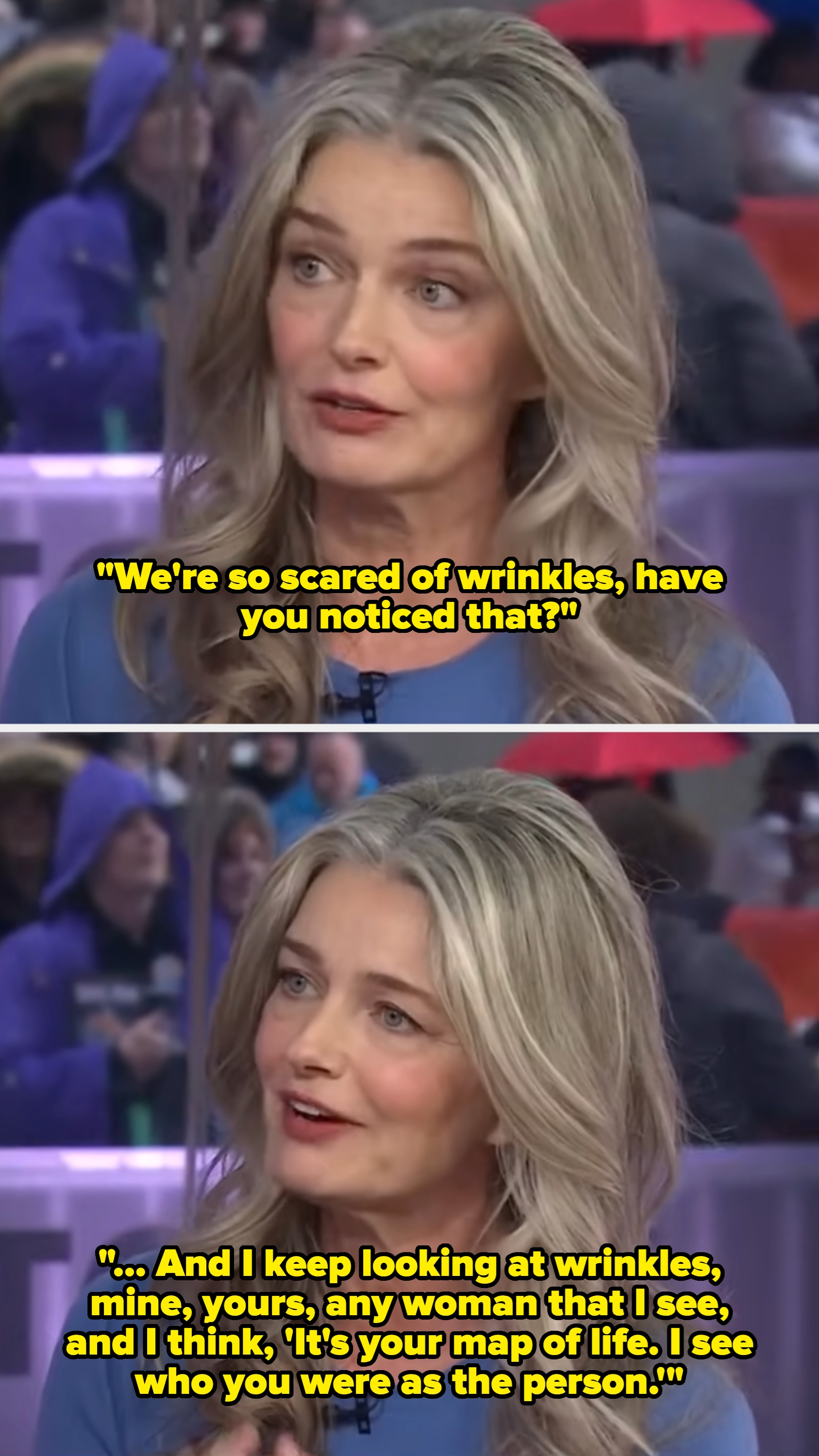 Person med langt bølget hår som snakker under et intervju på et sett med mennesker i bakgrunnen