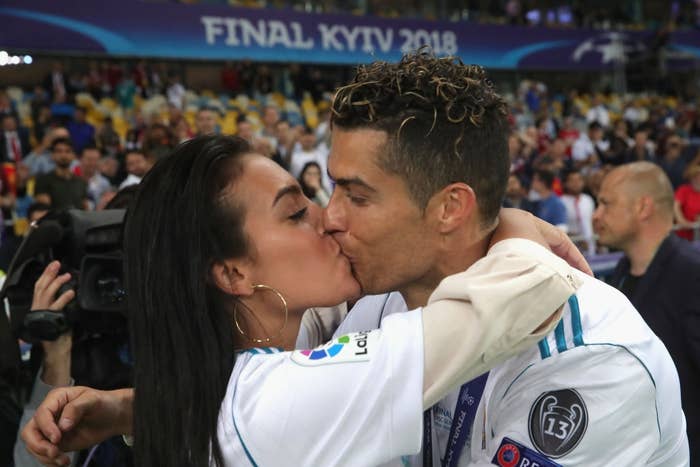 A soccer player in a uniform shares a celebratory kiss with a woman in a stadium during the 2018 final in Kyiv