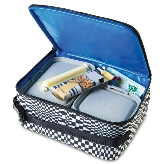 Lunchbox with checkered pattern, unzipped to show  2  nutrient  containers, a granola bar, drawstring  cheese, and a tiny  toothpaste conduit  inside