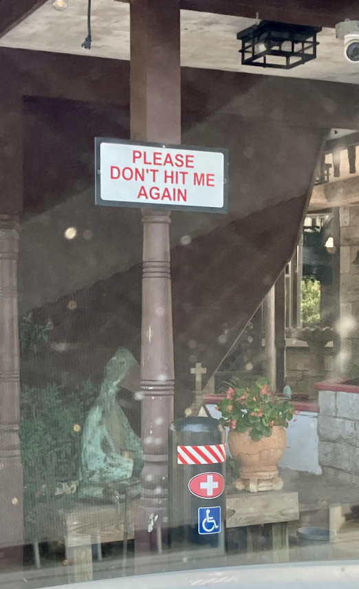 A humorous motion   connected  a structure  says "Please don't deed  maine  again," with adjacent    plants and a statue
