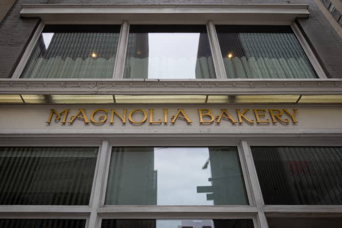 Magnolia Bakery storefront with large windows and a gold sign above the entrance