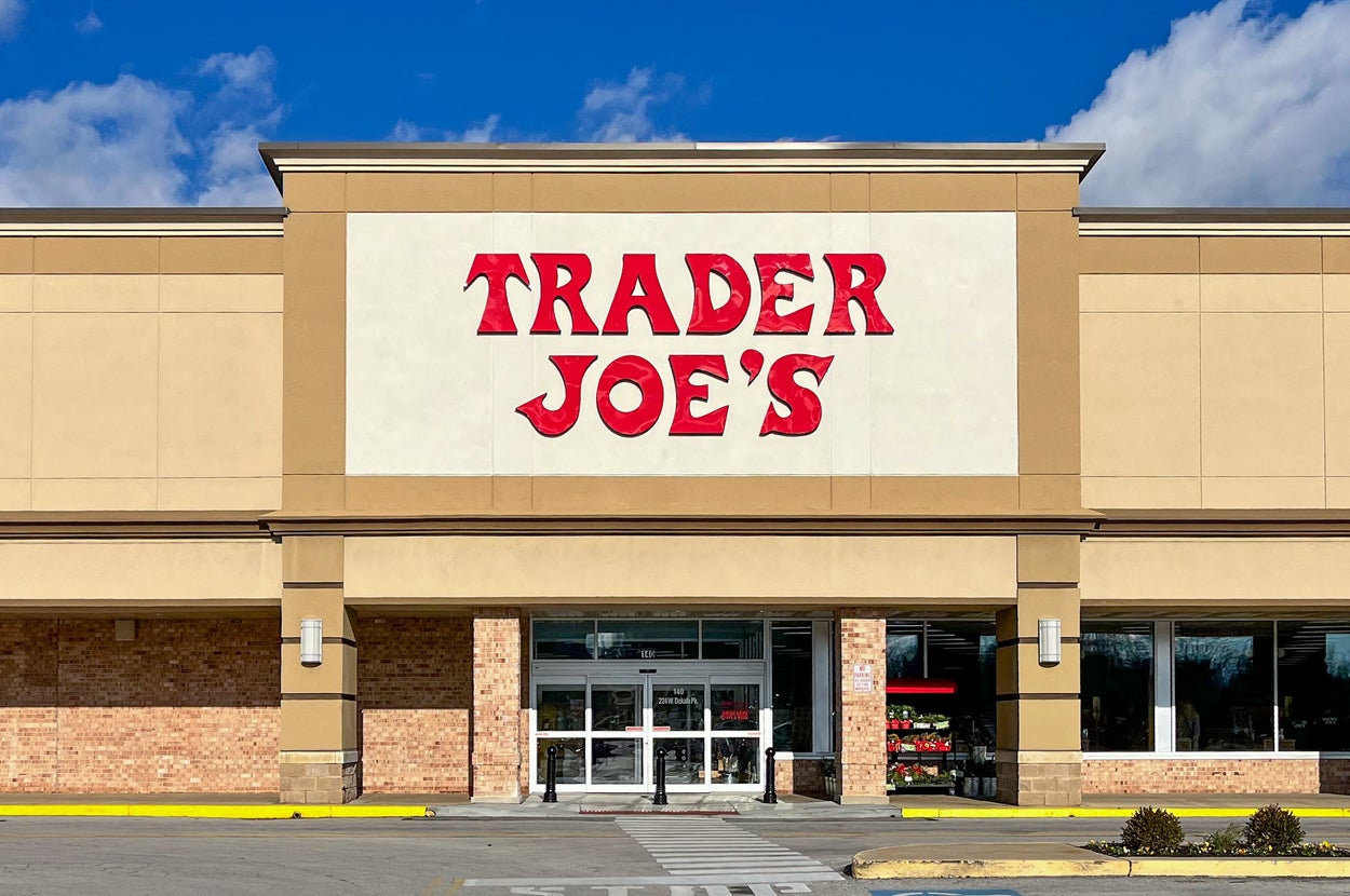Front entrance of a Trader Joe's store on a clear day, featuring the store's signature signage