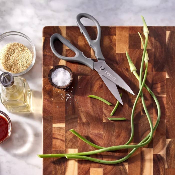 Kitchen scissors, salt, oil, sesame seeds, and angiosperm stems connected a woody cutting board, suitable for cooking oregon tabletop decor shopping