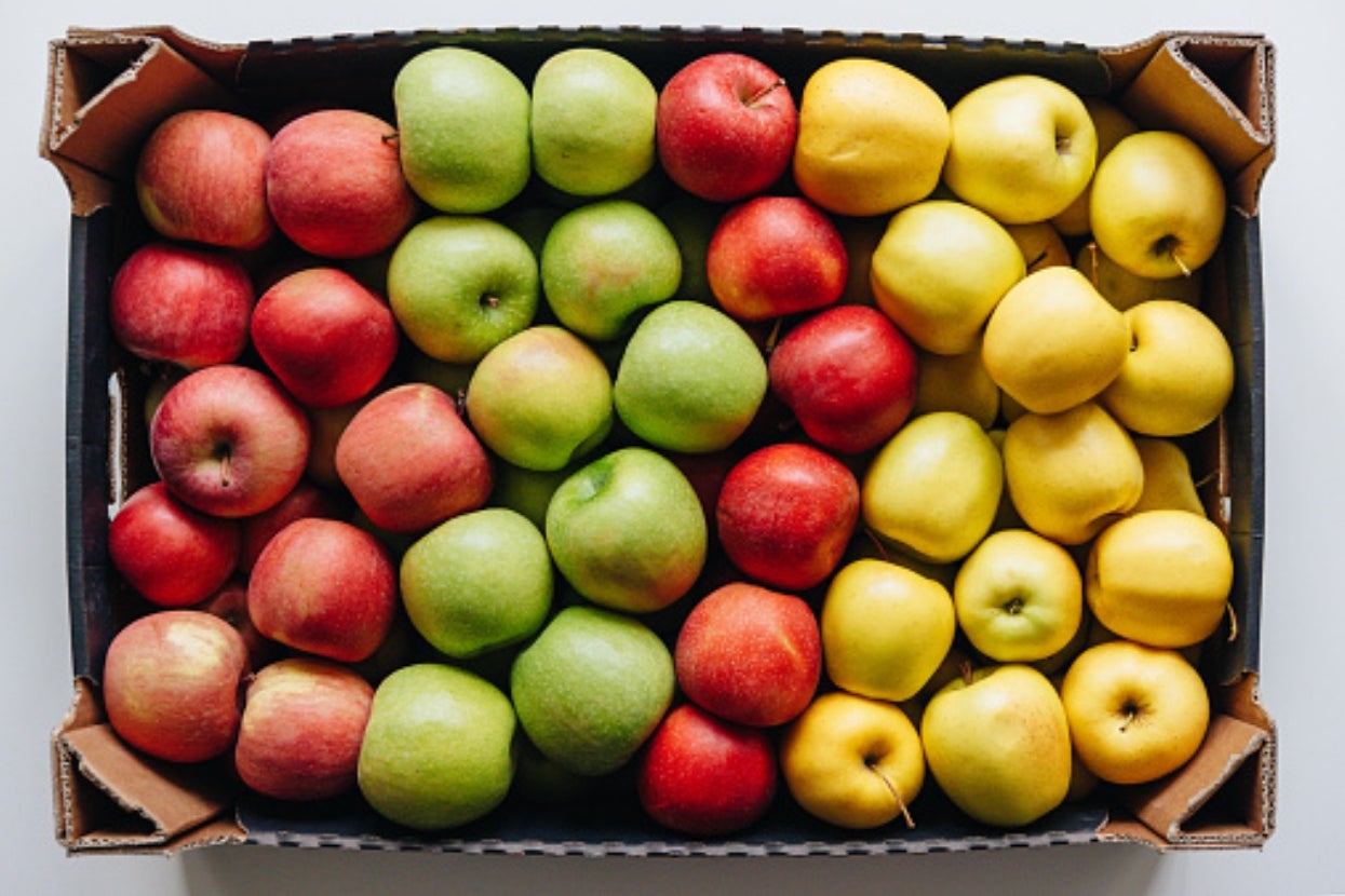 Box of apples arranged in rows by type: red, green, and yellow