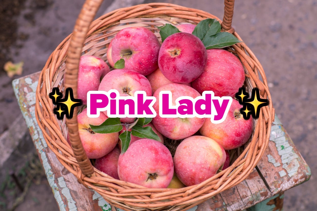 Basket filled with apples labeled "Pink Lady" surrounded by glowing sparkles