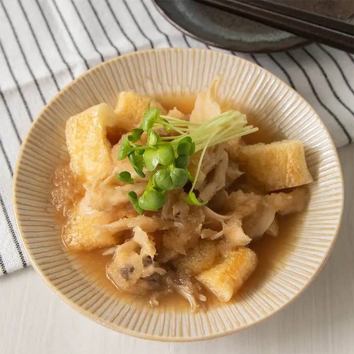 大根おろしの料理が皿に盛られています。盛り付けにカイワレが添えられています。